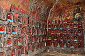 Myanmar, Burma, Nyaungshwe. Small Buddhas set into the temple wall, Shwe Yaunghwe Kyaung monastery, near Inle Lake.